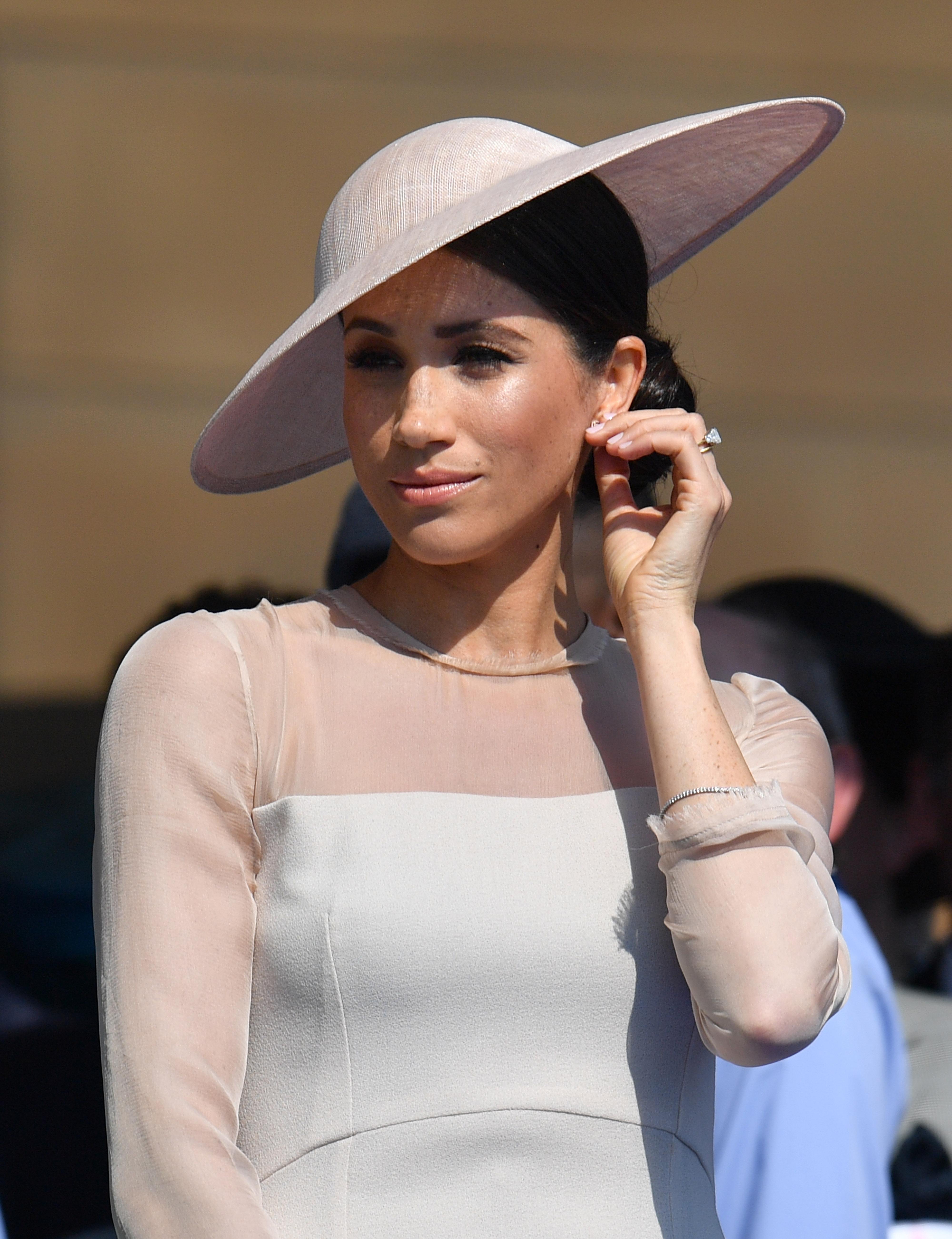 The Duchess of Sussex at a garden party at Buckingham Palace in London which she is attending as her first royal engagement after being married. The garden party was to mark the forthcoming 70th birthday of The Prince of Wales.